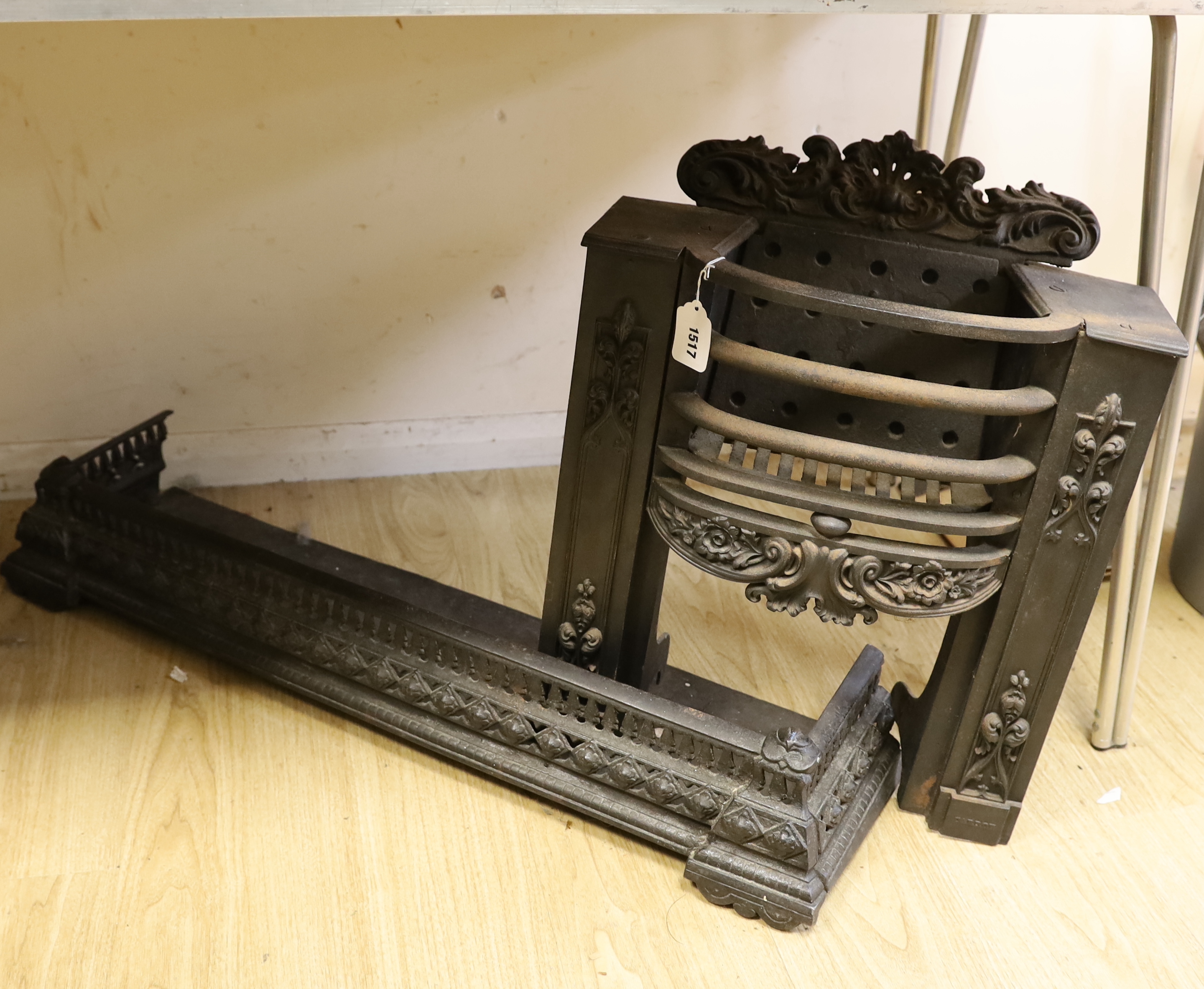 A cast iron and fire grate and fender, fire grate 52cm high